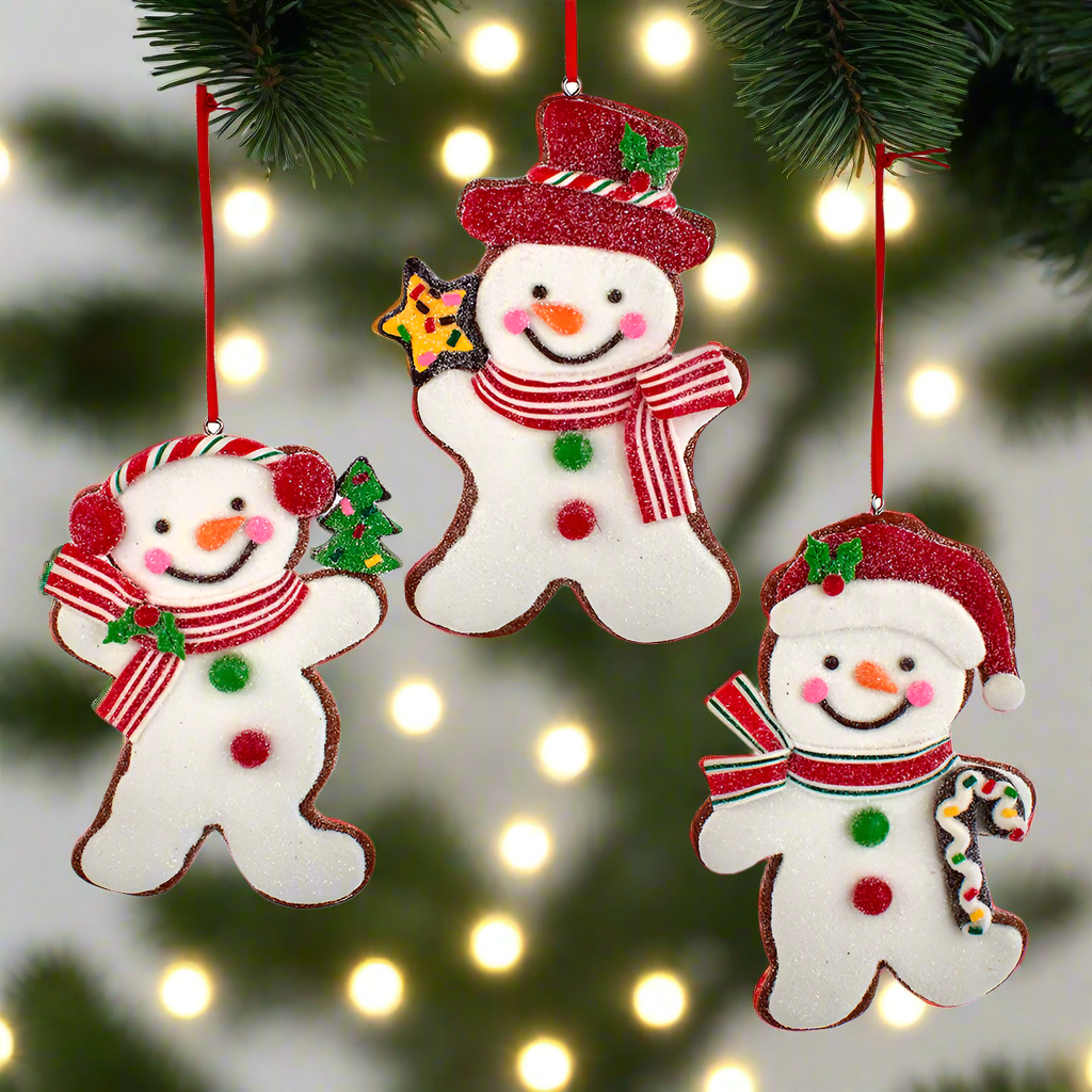 Three snowman-shaped Christmas ornaments hanging on a tree Christmas Cheer All Year