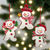 Three snowman-shaped Christmas ornaments hanging on a tree Christmas Cheer All Year