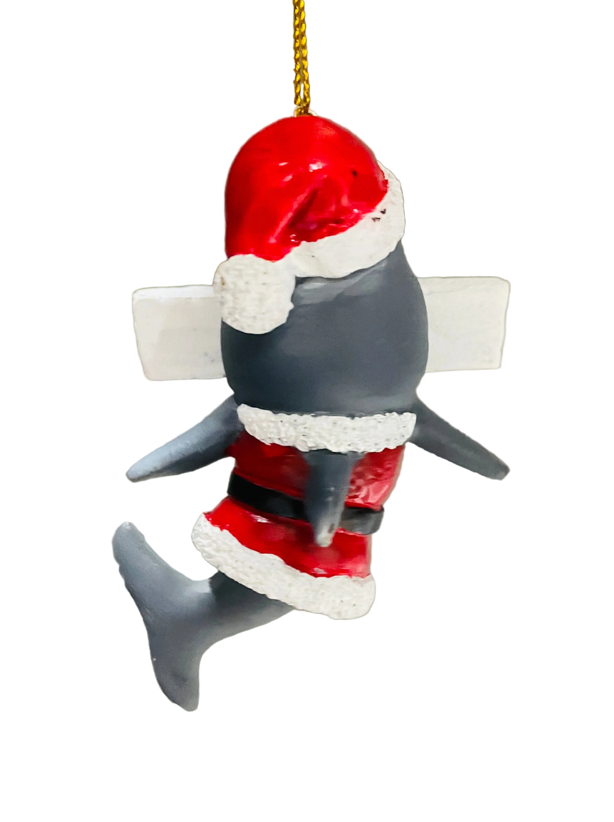 A small shark Christmas ornament wearing a red Santa hat and Santa suit with white trim, hanging by a gold string