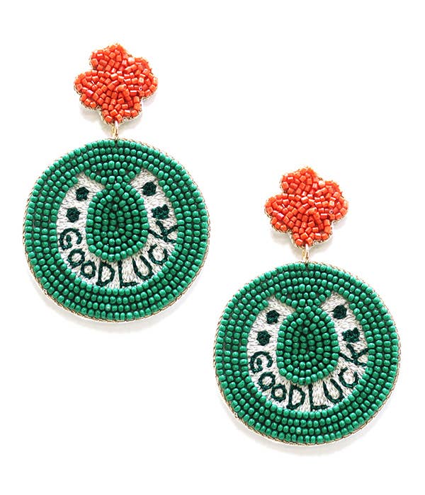 Green beaded earrings with 'good luck' text and coral flower tops 