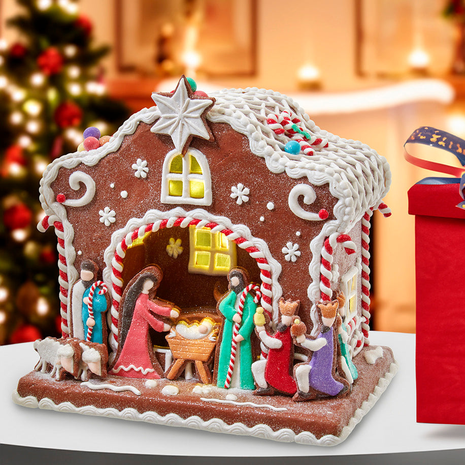 Christmas Cheer All Year Decorative gingerbread house with Kurt Adler Battery Operated gingerbread nativity scene on a table 
