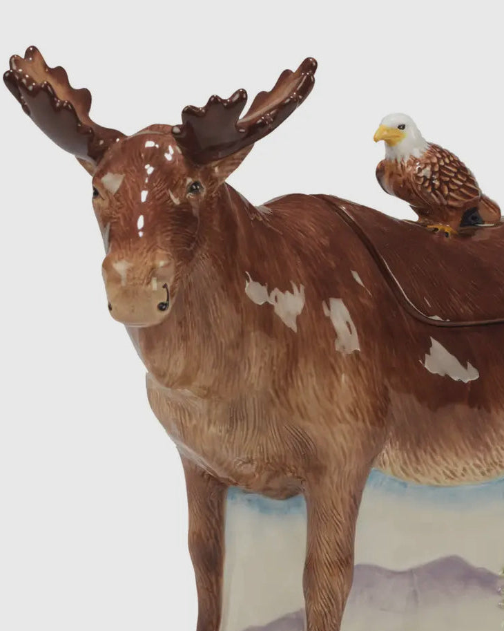 A ceramic moose cookie jar with a small bald eagle perched on its back Christmas cheer all year kitchen decor