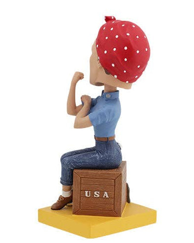 Christmas Cheer All Year Rosie the Riveter Bobblehead figure of a woman with a red bandana and blue shirt, sitting on a box with 'USA' and 'We Can Do It!' text.