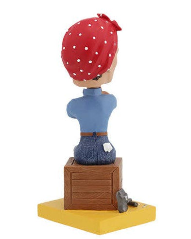 Christmas Cheer All Year Rosie the Riveter Bobblehead figure of a woman with a red bandana and blue shirt, sitting on a box with 'USA' and 'We Can Do It!' text.