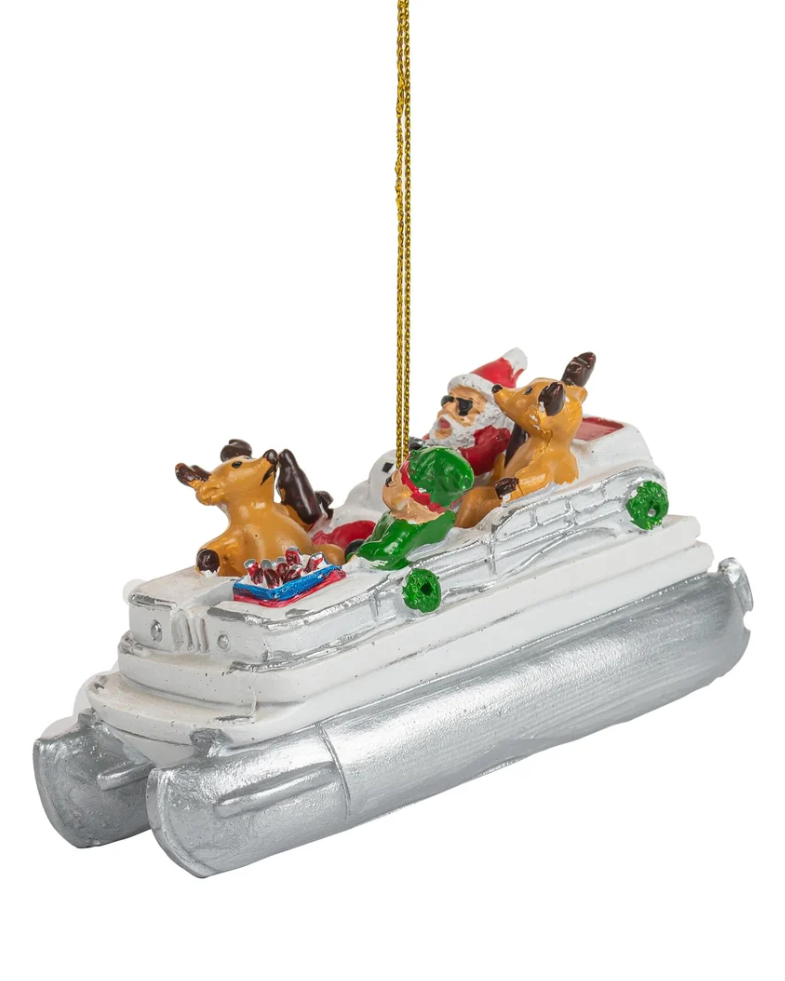 Christmas Cheer All Year Christmas ornament shaped like a white and silver pontoon boat party cove carrying Santa Claus and three reindeer, with beer with a gold hanging string