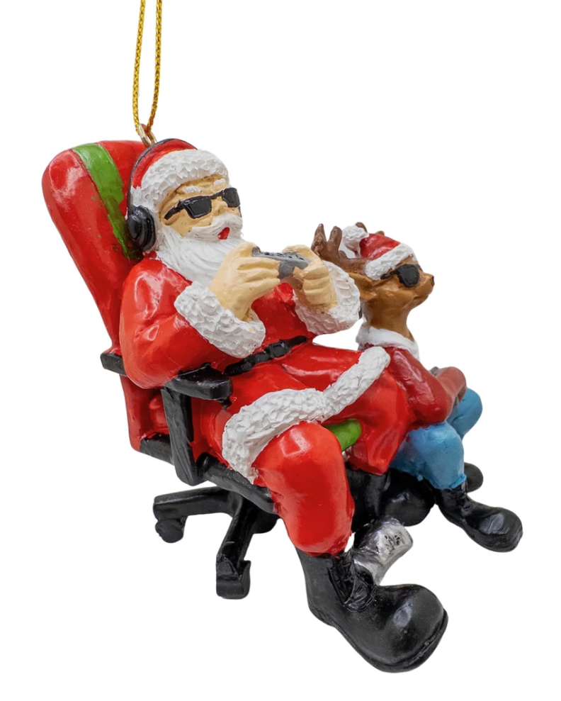 Christmas Cheer All Year Christmas gamer ornament depicting Santa Claus wearing sunglasses and headphones in a red office chair playing video games with a reindeer