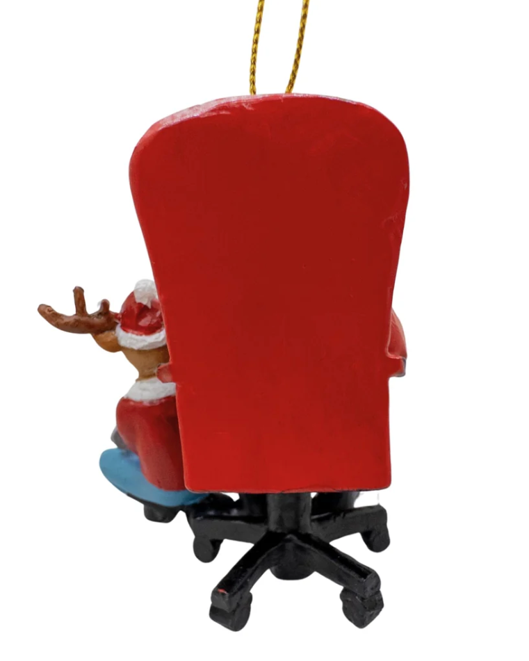 Christmas Cheer All Year Christmas gamer ornament depicting a reindeer in a Santa hat sitting behind a red office chair with a black wheeled base, hanging from a gold string