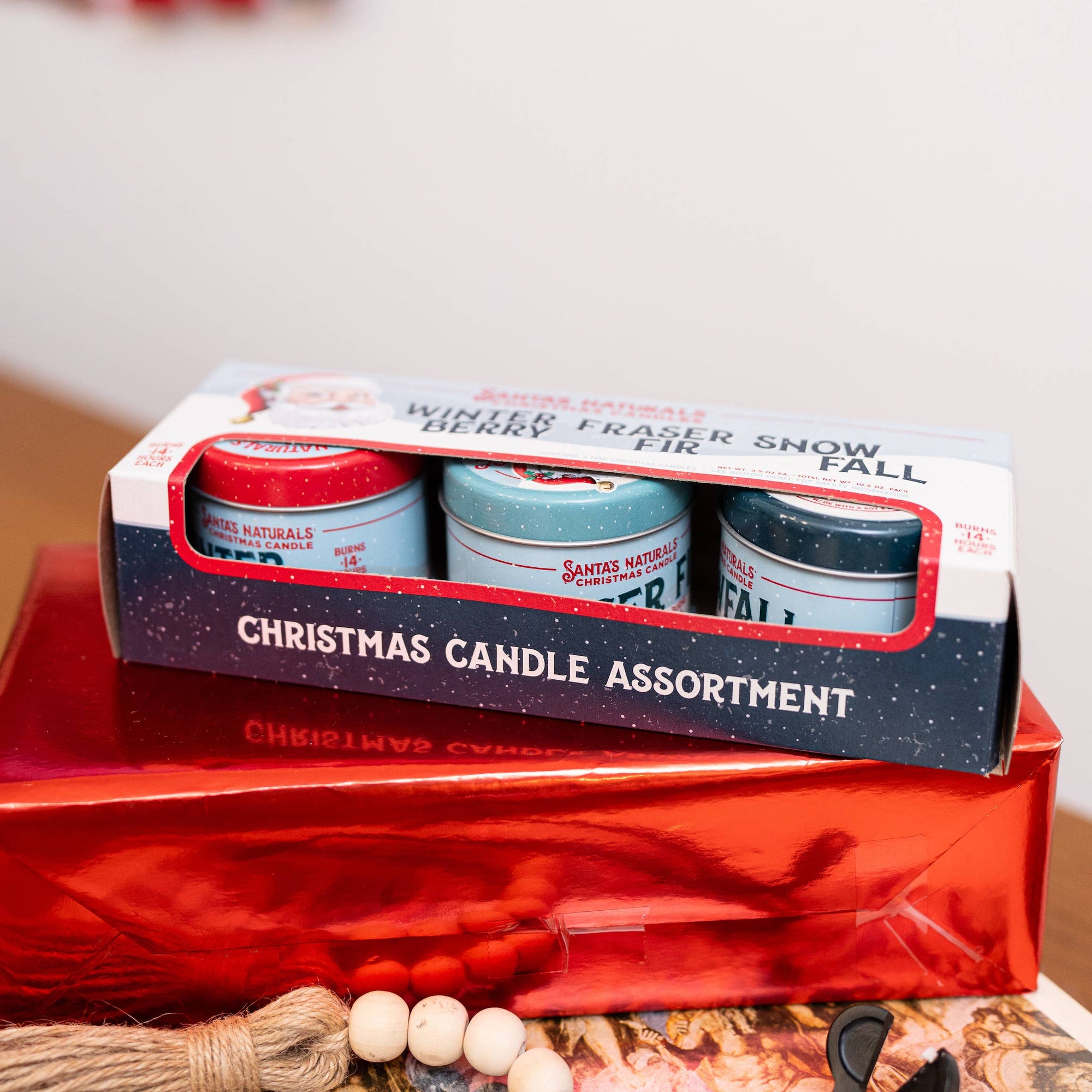 Christmas Cheer All Year Box of Santa's Naturals Christmas candles with various scents on red gift box