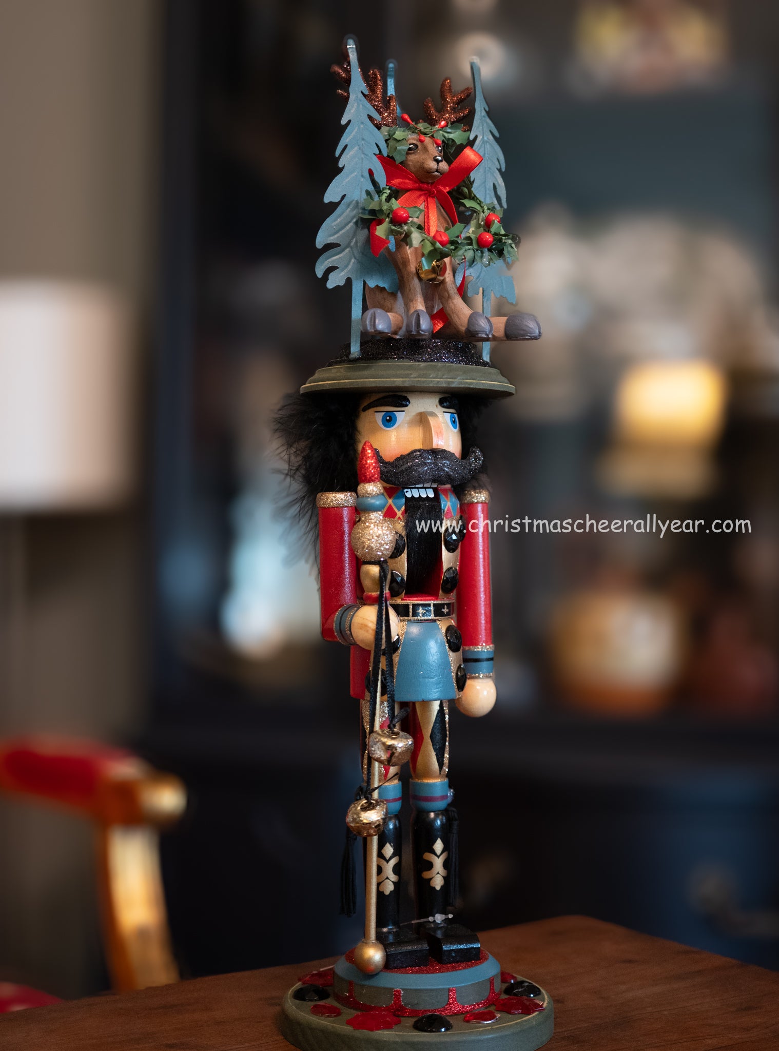 Decorative nutcracker with reindeer and trees on a blurred background