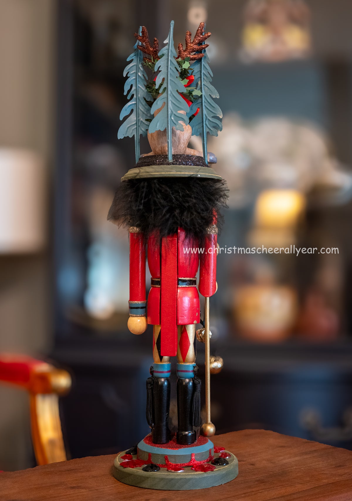 Decorative nutcracker figure with a festive hat on a wooden surface.