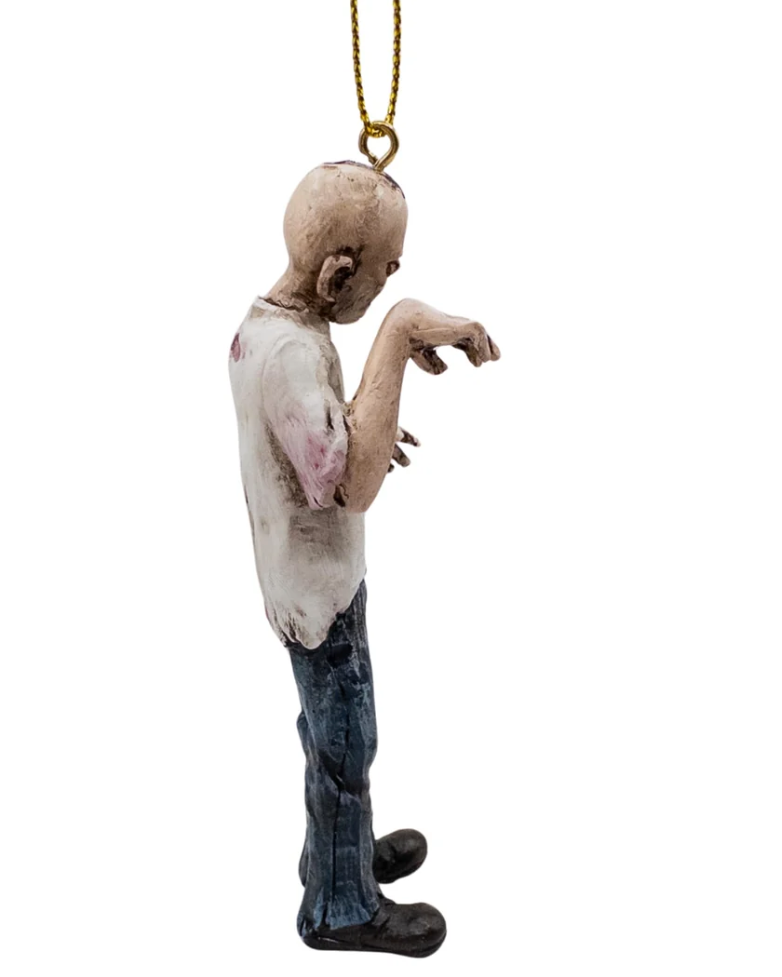 Christmas Cheer All Year A zombie Halloween ornament hanging by a gold string, featuring a distressed, decaying figure with an open shirt, ribs exposed, ripped jeans, bloody leg and a bloody head with skull exposed