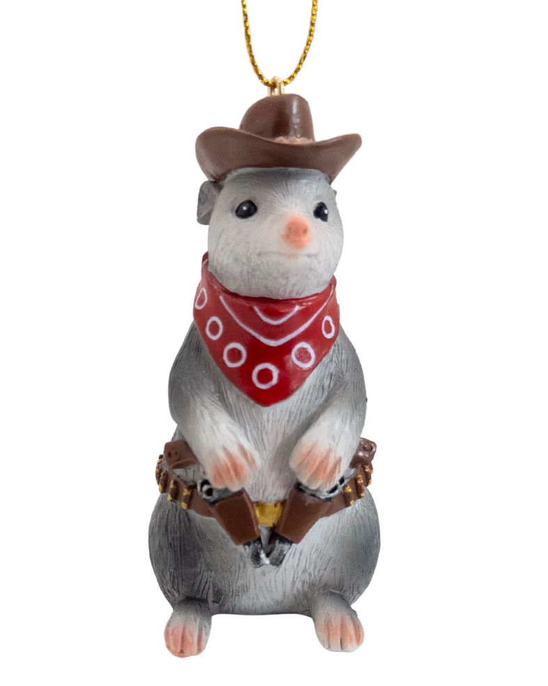Christmas Cheer All Year cowboy opossum ornament dressed in western attire, wearing a brown cowboy hat, a red bandana with white dots, and a brown holster with a revolver, hanging from a gold string 