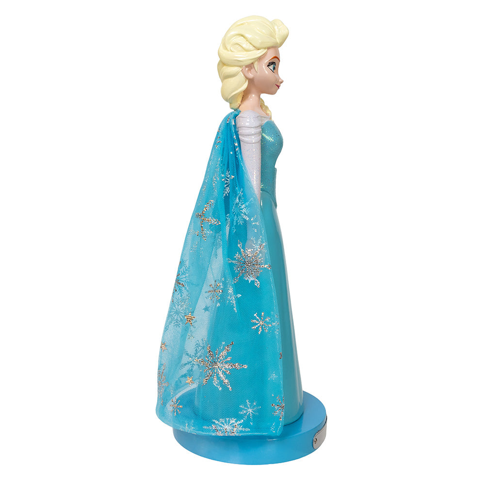 Elsa doll from Frozen with blue gown and cape on a white background
