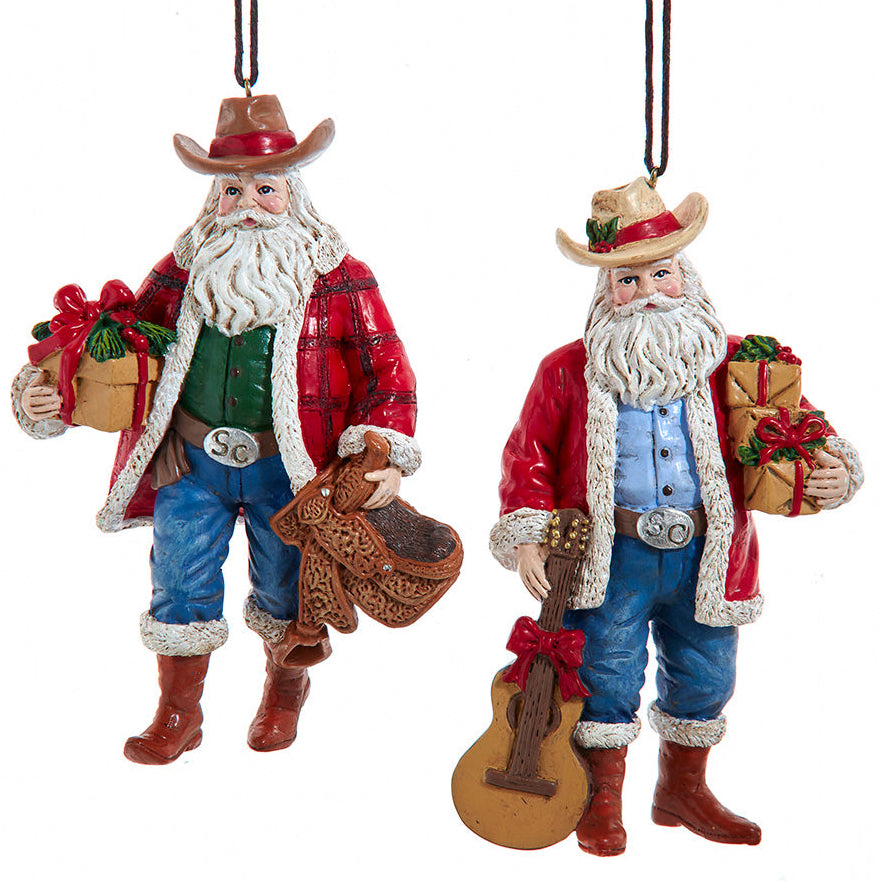 Two cowboy-themed Santa Claus figurines with a guitar and gift box on a white background Western Texas theme ornaments Christmas Cheer All Year Kurt Adler