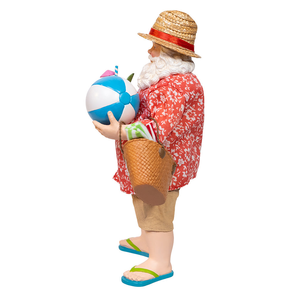 Christmas Cheer All Year Santa Claus figure in beach attire holding a drink, beach ball, and 'VACAY' bag on a white background