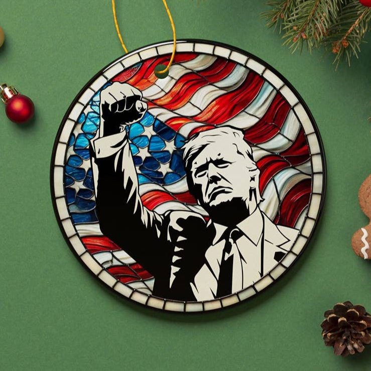 Decorative President Trump ornament with a stylized portrait and American flag design on stained glass with his fight fight fight arm in air 