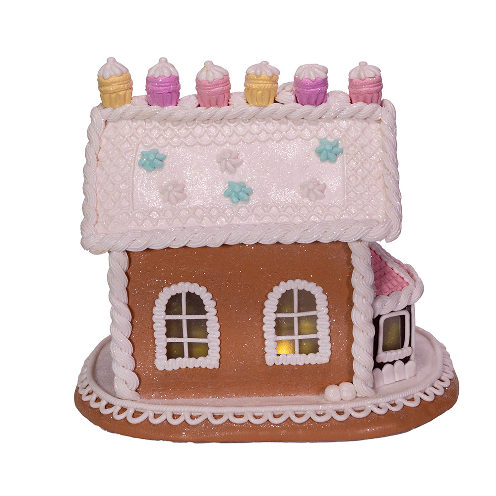 Decorative gingerbread house with icing details on a white background