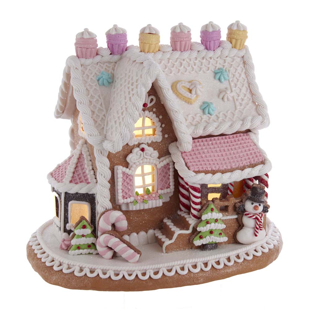 Kurt Adler pink frosted gingerbread house with candy decorations on a white background