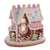 Kurt Adler pink frosted gingerbread house with candy decorations on a white background