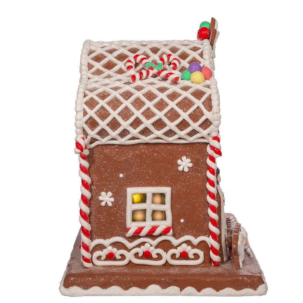 Gingerbread house with candy decorations on a white background