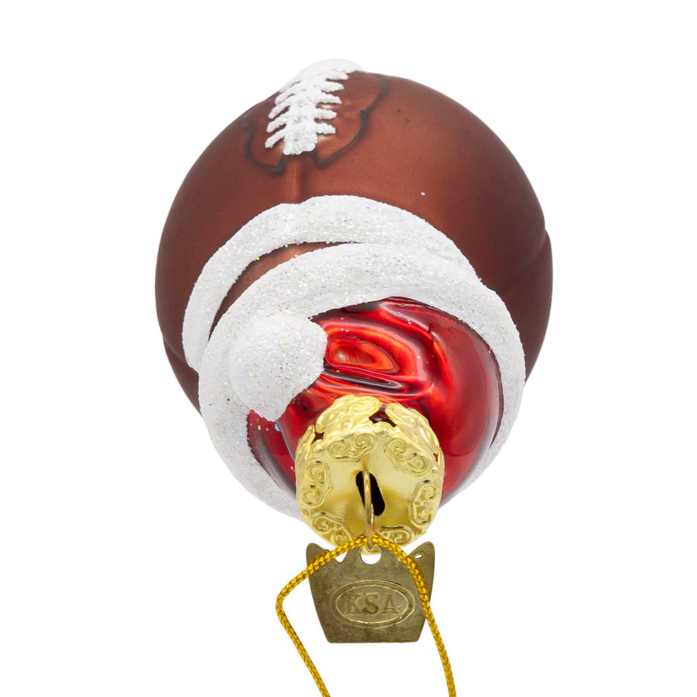Christmas Cheer All Year Decorative football ornament with a gold bell on a white background