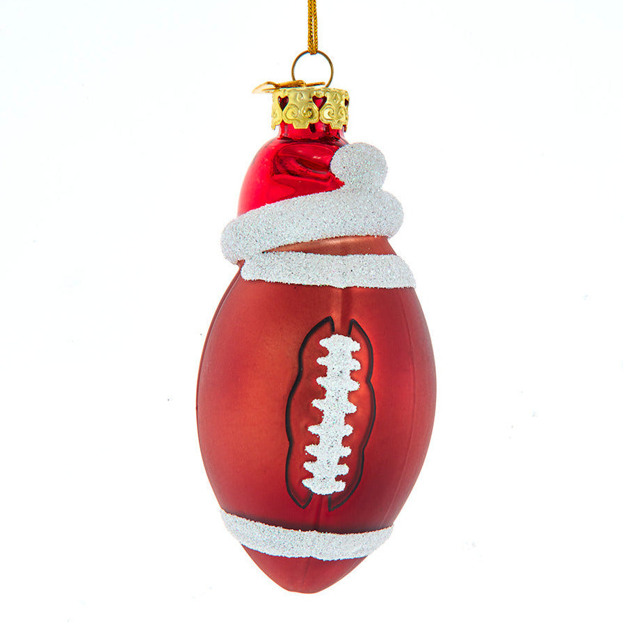 Christmas Cheer All Year Decorative football ornament with Santa hat on a white background