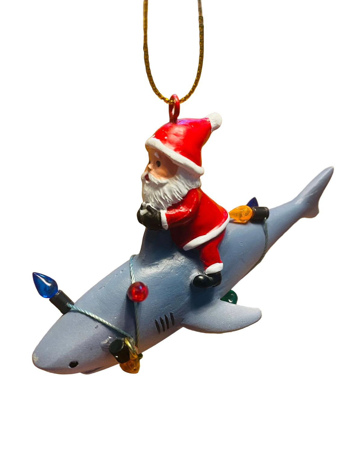 Christmas Cheer All year A Santa Claus Christmas ornament riding a gray shark, decorated with small holiday lights