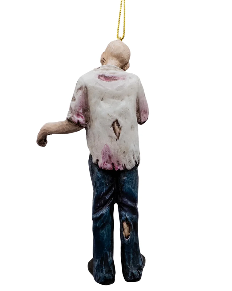 Christmas Cheer All Year A zombie Halloween ornament hanging by a gold string, featuring a distressed, decaying figure with an open shirt, ribs exposed, ripped jeans, bloody leg and a bloody head with skull exposed